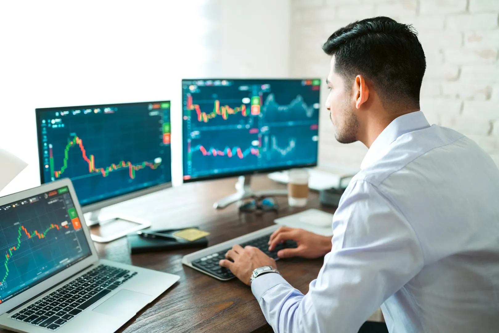 Financial analyst at multiple screens — NLB Group AI governance